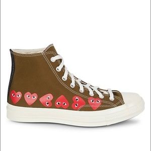 Comme des Garçons hearts wraps the sides and back of the high-top sneaker
